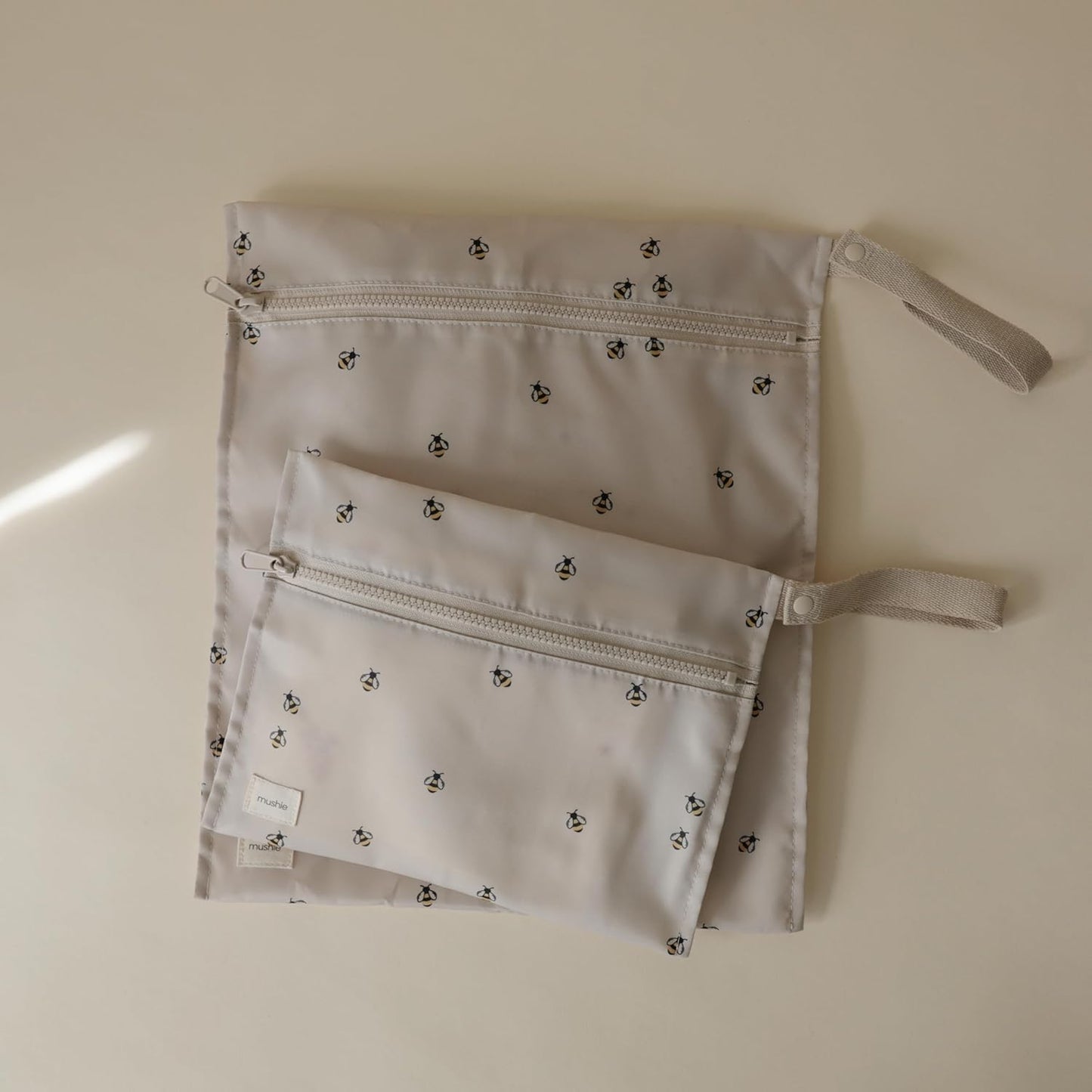 mushie Water Resistant Wet Bags | Large & Small Reusable Storage Bag for Baby Items and Travel | Zippered Pockets with Handle | Machine Washable, Set of 2 (Bees)
